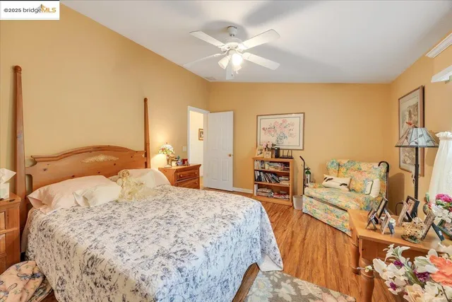 a bedroom with a bed a couch and a chandelier