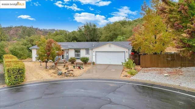a view of a patio with table and chairs under an umbrella