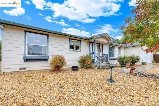 a backyard of a house with table and chairs