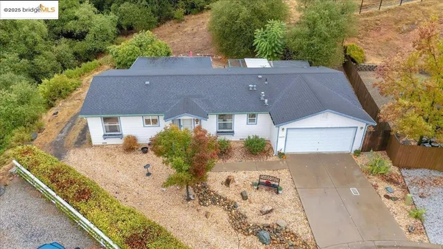 an aerial view of a house with a yard