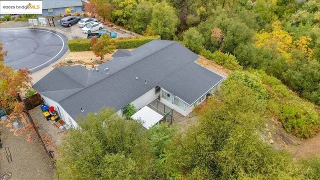 an aerial view of a house with a garden and trees
