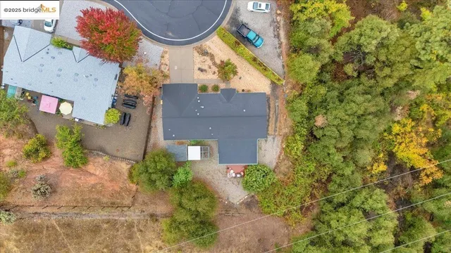 an aerial view of a house with a yard and trees