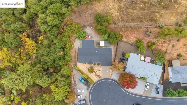 an aerial view of a house with a yard swimming pool and outdoor seating