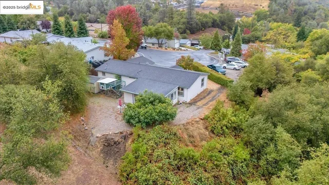 an aerial view of a house with a yard and lake view