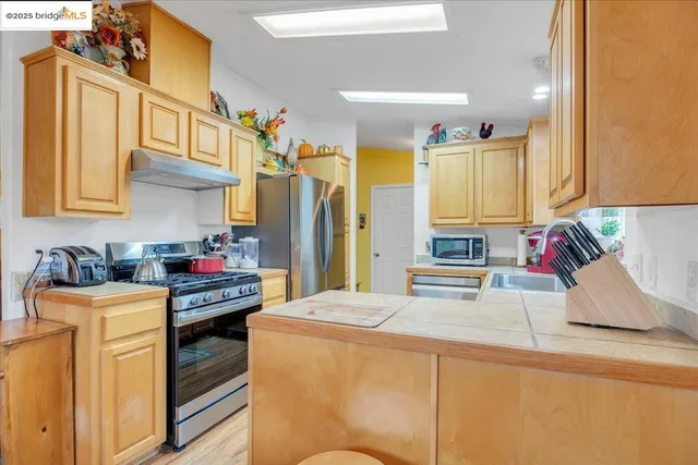 a kitchen with stainless steel appliances cabinets a stove and a refrigerator