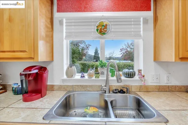 a bathroom with a sink and a large window