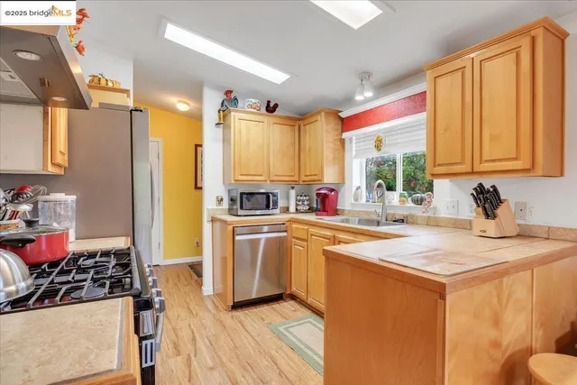 a kitchen with a sink stove and refrigerator