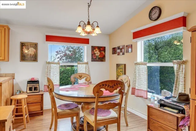 a dining room with furniture a flat screen tv and a large window