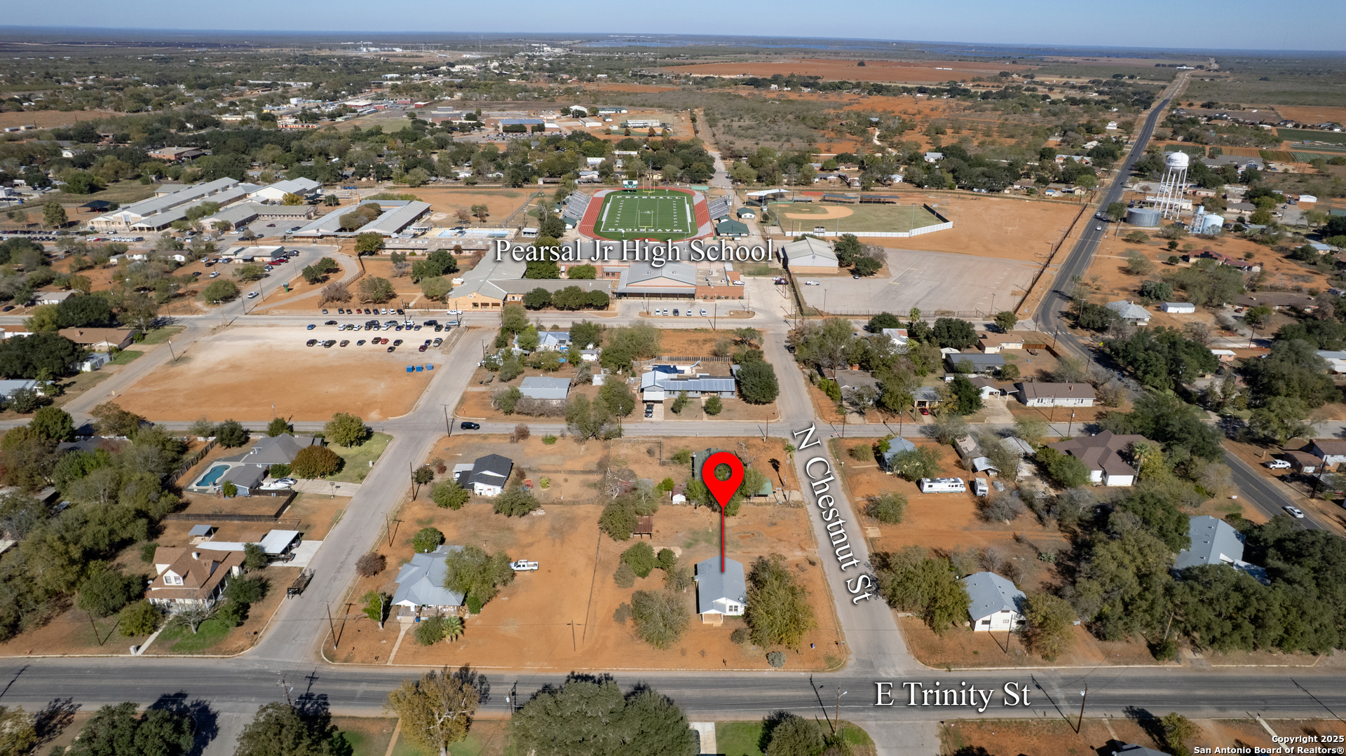 719 East Trinity Street Pearsall, TX 78061 - Photo 12 of 26 an aerial view of residential building and parking space