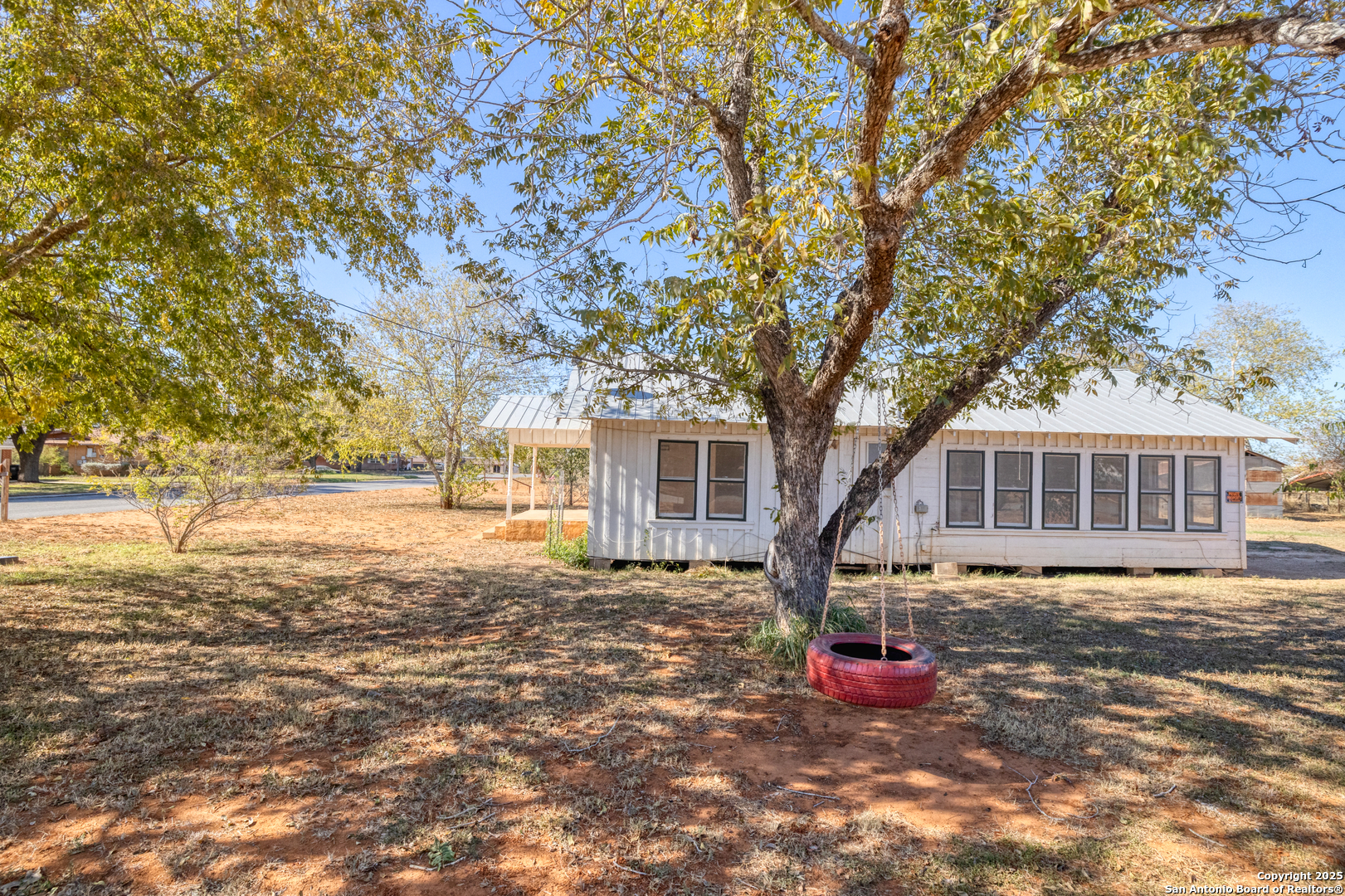 719 East Trinity Street Pearsall, TX 78061 - Photo 2 of 26 a front view of a house with a yard