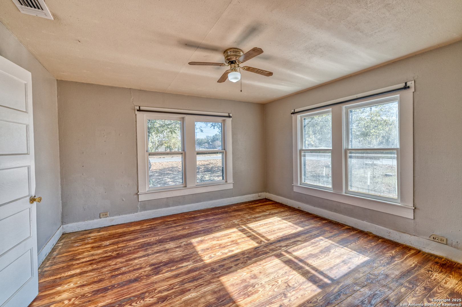 719 East Trinity Street Pearsall, TX 78061 - Photo 21 of 26 a view of an empty room with a window