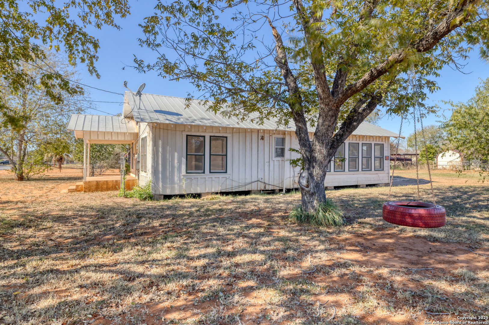 719 East Trinity Street Pearsall, TX 78061 - Photo 26 of 26 a house with trees in front of it