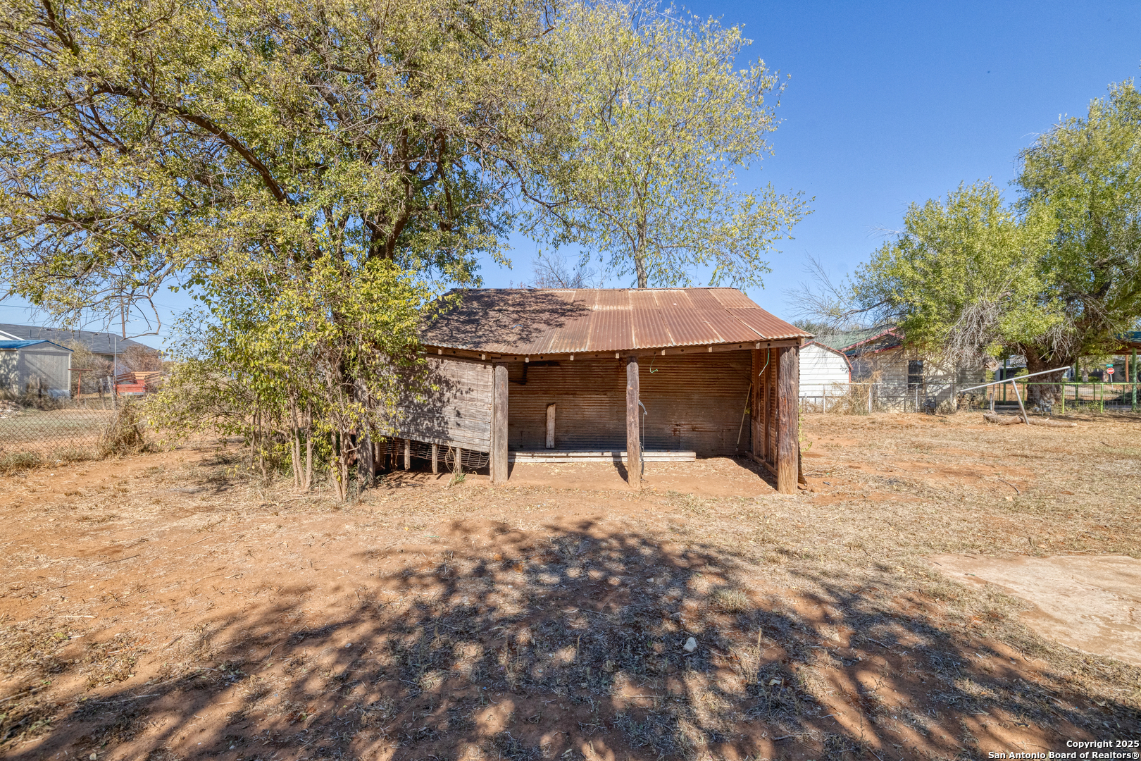 719 East Trinity Street Pearsall, TX 78061 - Photo 7 of 26 a view of a house with a yard