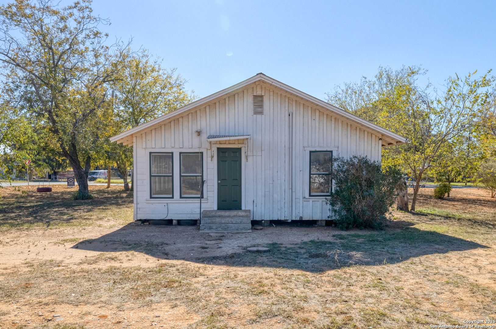 719 East Trinity Street Pearsall, TX 78061 - Photo 8 of 26 a front view of a house with a yard and garage