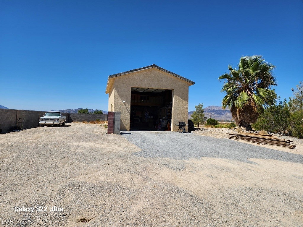 1101 East Blosser Ranch Road Pahrump, NV 89060 - Photo 2 of 50 View of RV Garage
outdoor structure with a mountain view and driveway