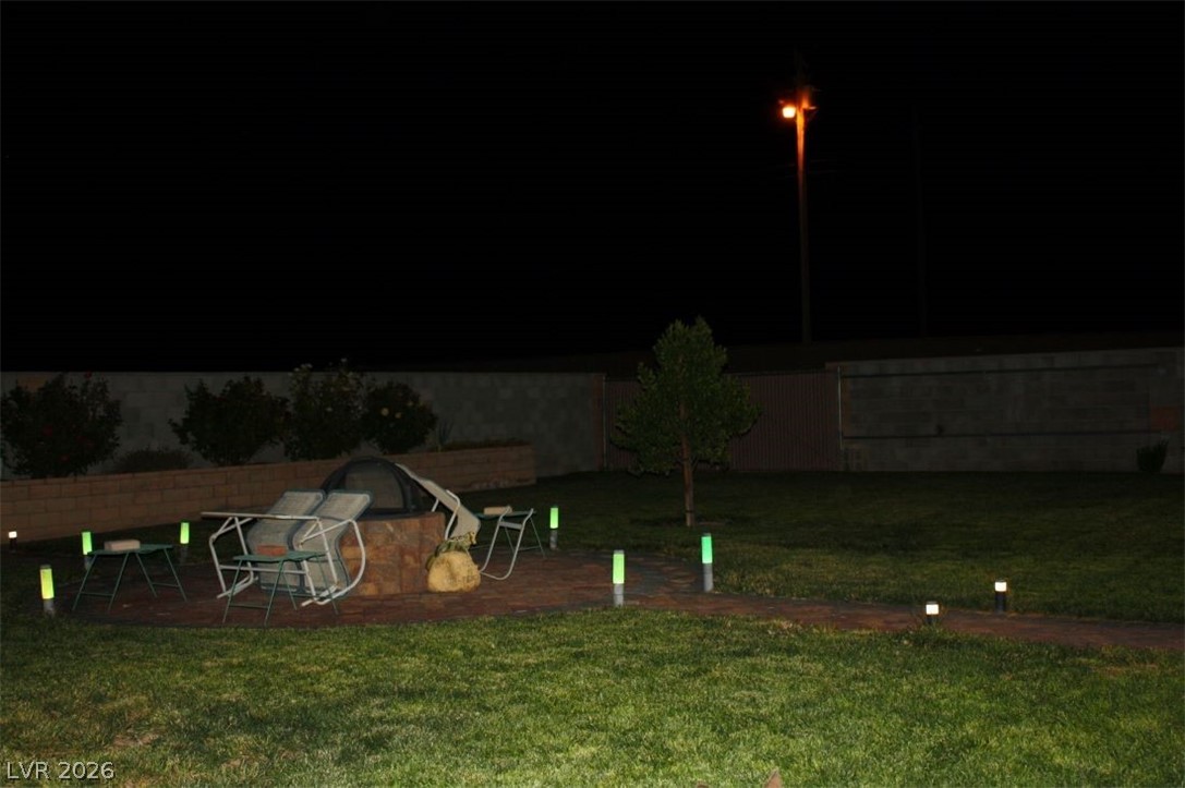 1101 East Blosser Ranch Road Pahrump, NV 89060 - Photo 39 of 50 Yard at night featuring a yard and a patio