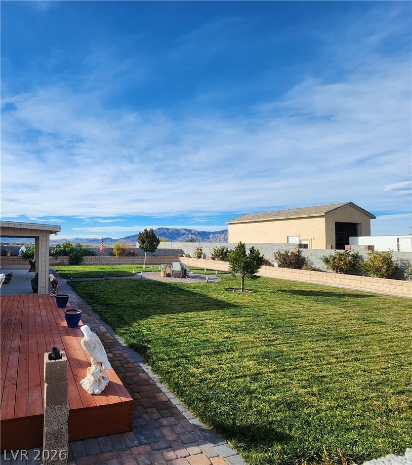 1101 East Blosser Ranch Road Pahrump, NV 89060 - Photo 44 of 50 View of green lawn with a mountain view, a patio, and a gazebo