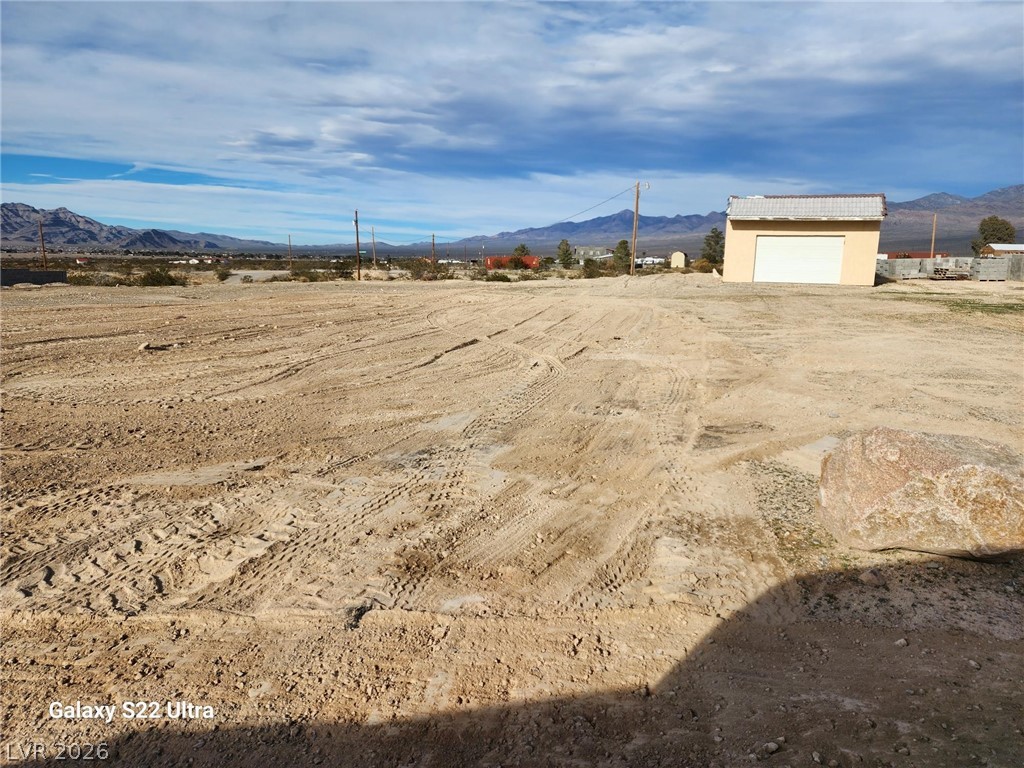 1101 East Blosser Ranch Road Pahrump, NV 89060 - Photo 48 of 50 Well garage plus View of yard with a mountain view and an outdoor structure