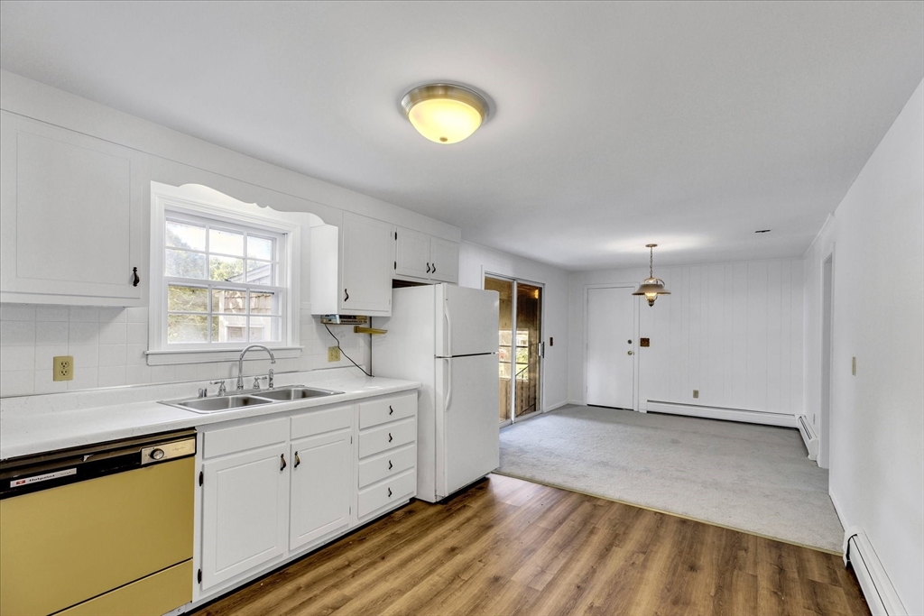 199 Hamden Circle Barnstable, MA 02601 - Photo 5 of 13 a kitchen with cabinets and wooden floor
