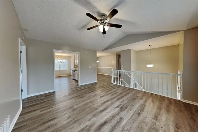 a view of an empty room and wooden floor