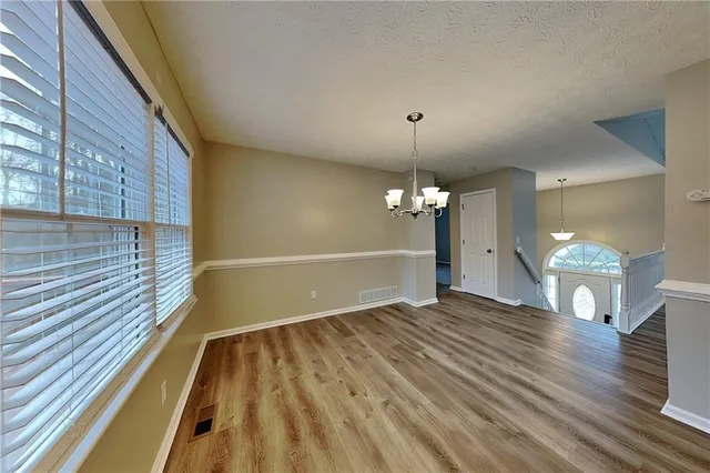 a view of a room with wooden floor fan and window