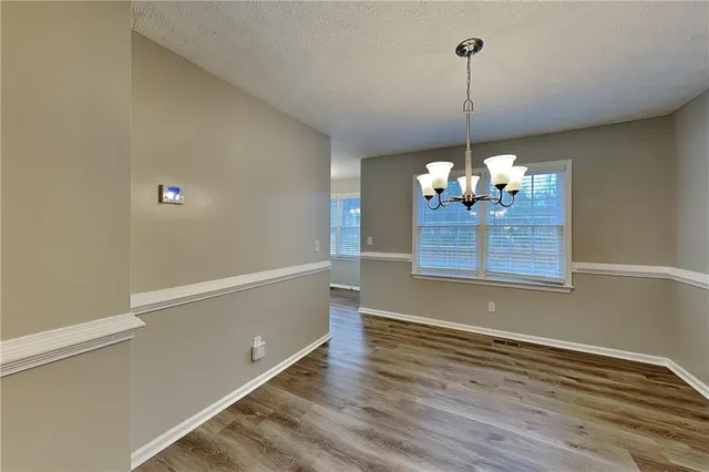 a view of a room with wooden floor and flat screen tv