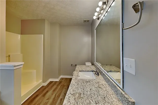 a view of water heater room with wooden floor