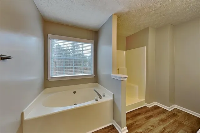 a bathroom with a tub and shower
