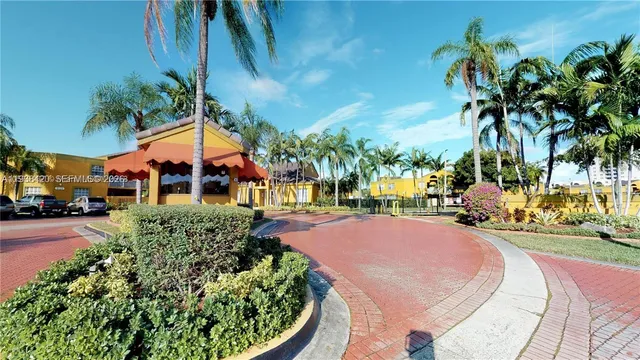 a tennis court with palm trees