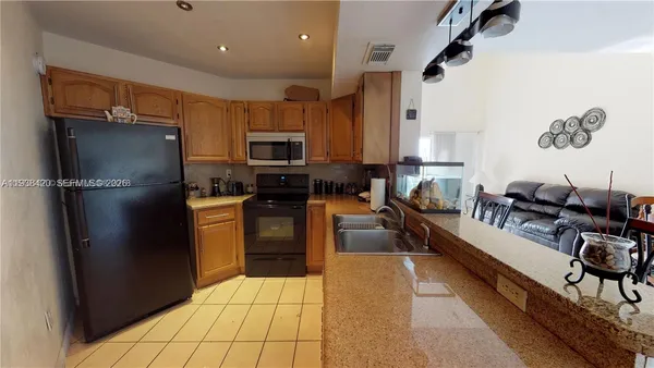 a kitchen with stainless steel appliances a refrigerator sink and stove