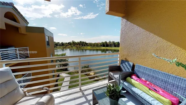 a view of a balcony with wooden floor and outdoor seating