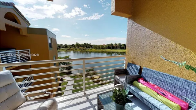 a view of a balcony with wooden floor and outdoor seating