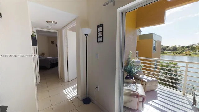 a view of a balcony and chair and floor to ceiling window