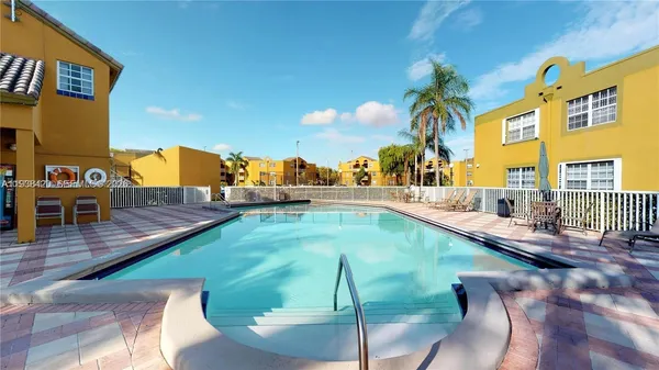 a view of swimming pool with a patio and a yard