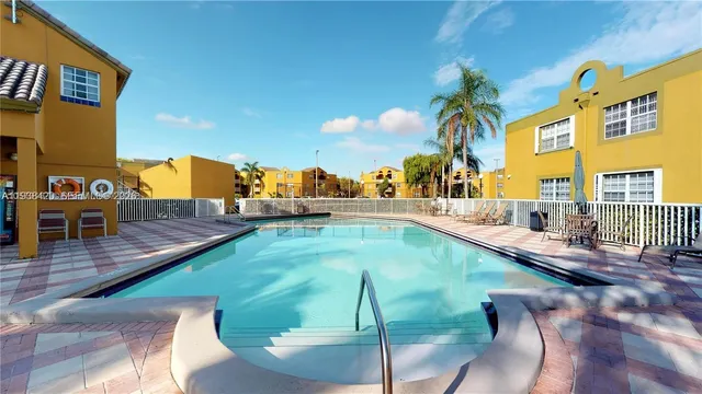 a view of swimming pool with a patio and a yard