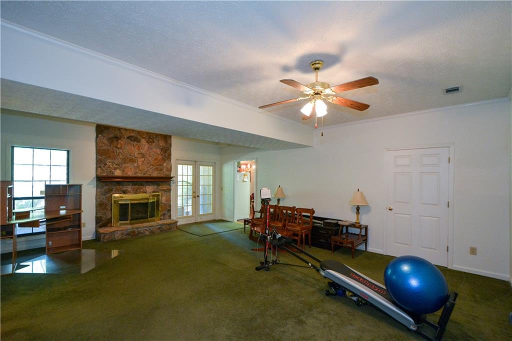 130 Hawn Road Fayetteville, GA 30215 - Photo 34 of 67 a living room with furniture pool table and a fireplace