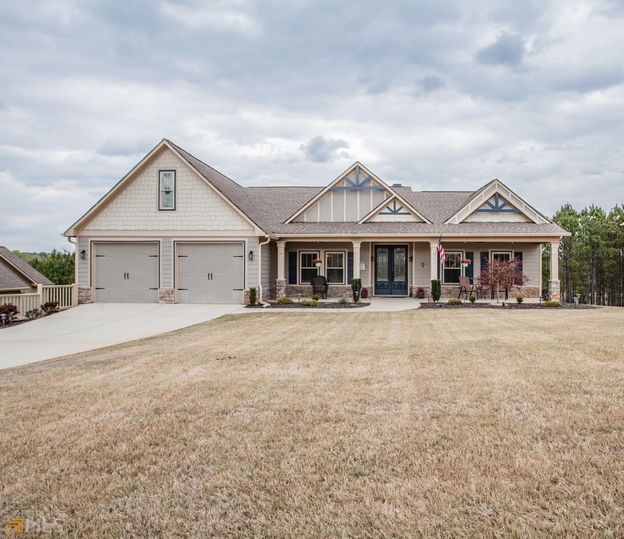 209 Red Jasper Road Villa Rica, GA 30180 - Photo 1 of 1 a front view of a house with a garden and trees