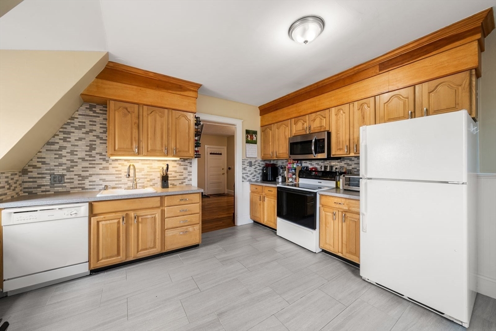 4 Alden Street, Unit 3 Danvers, MA 01923 - Photo 11 of 33 a kitchen with granite countertop stainless steel appliances and refrigerator