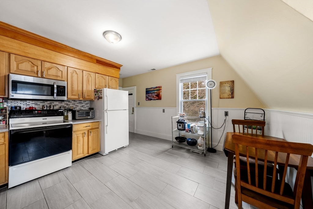 4 Alden Street, Unit 3 Danvers, MA 01923 - Photo 12 of 33 a kitchen with furniture a stove and a refrigerator