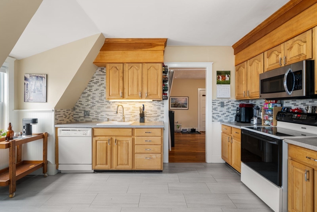 4 Alden Street, Unit 3 Danvers, MA 01923 - Photo 14 of 33 a kitchen with stainless steel appliances a stove sink and microwave
