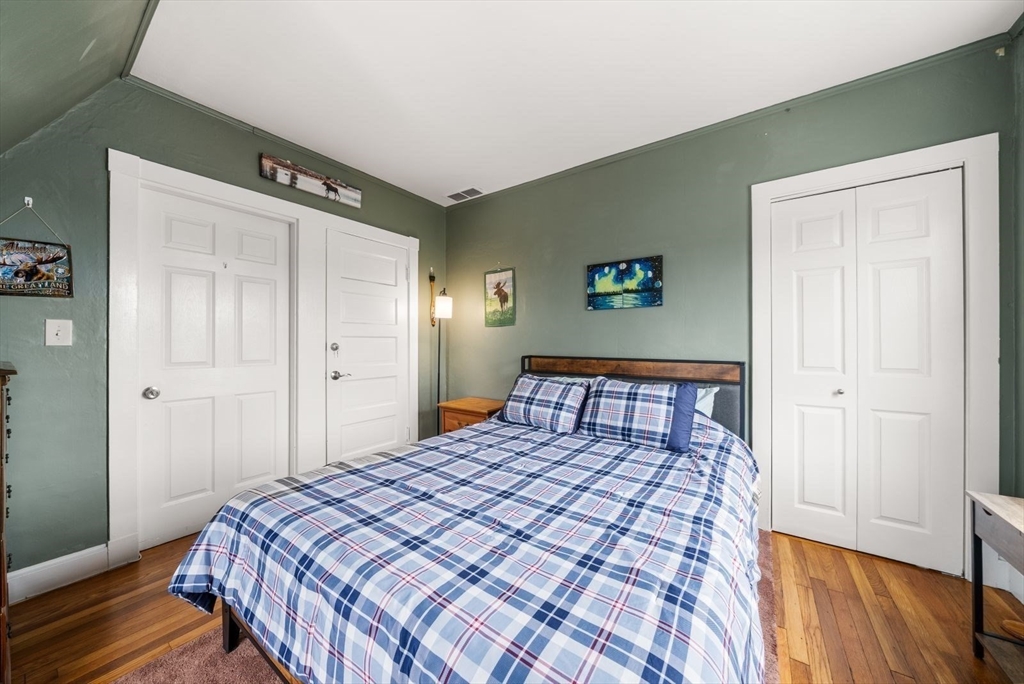 4 Alden Street, Unit 3 Danvers, MA 01923 - Photo 15 of 33 a bedroom with a bed and wooden floor