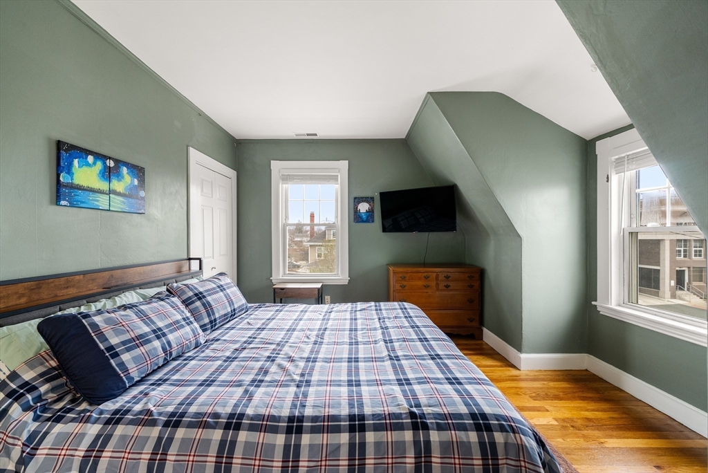 4 Alden Street, Unit 3 Danvers, MA 01923 - Photo 16 of 33 a bedroom with a bed and wooden floor