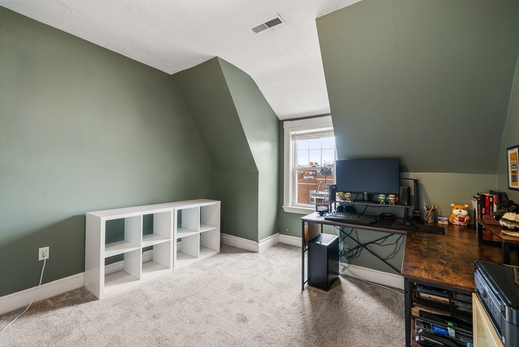 4 Alden Street, Unit 3 Danvers, MA 01923 - Photo 19 of 33 a room with furniture a rug and a window