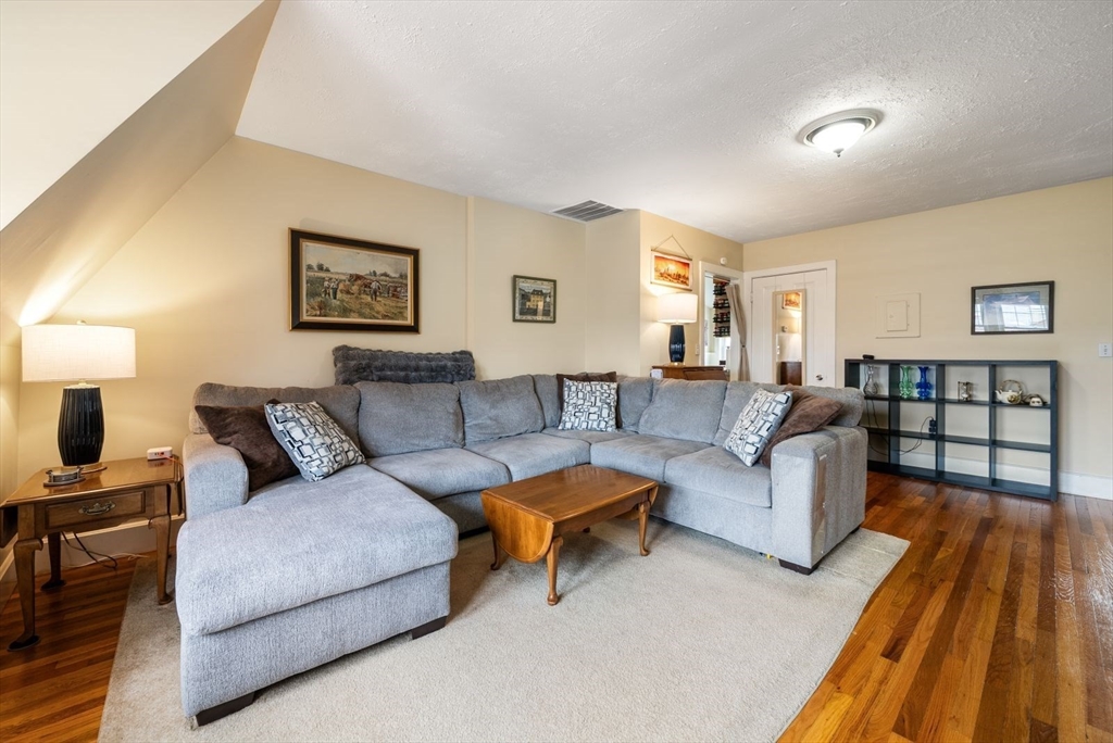 4 Alden Street, Unit 3 Danvers, MA 01923 - Photo 2 of 33 a living room with furniture and a lamp
