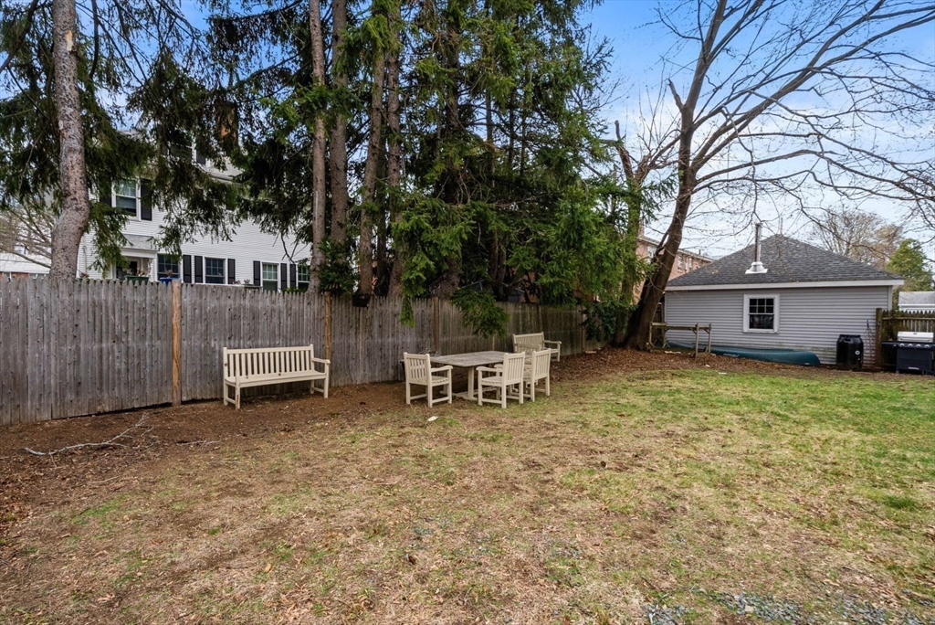 4 Alden Street, Unit 3 Danvers, MA 01923 - Photo 28 of 33 a view of a house with a chairs and table in a backyard