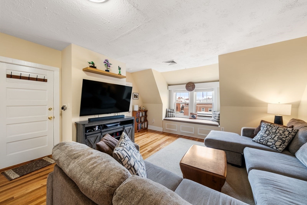 4 Alden Street, Unit 3 Danvers, MA 01923 - Photo 5 of 33 a living room with furniture and a flat screen tv