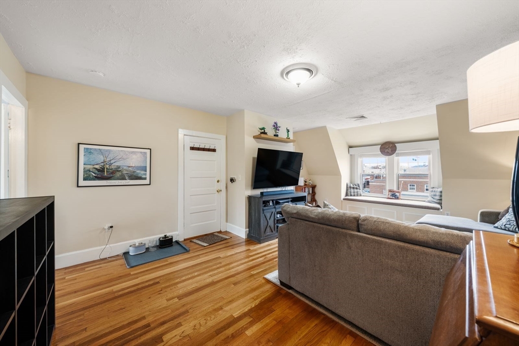 4 Alden Street, Unit 3 Danvers, MA 01923 - Photo 7 of 33 a living room with furniture and a flat screen tv