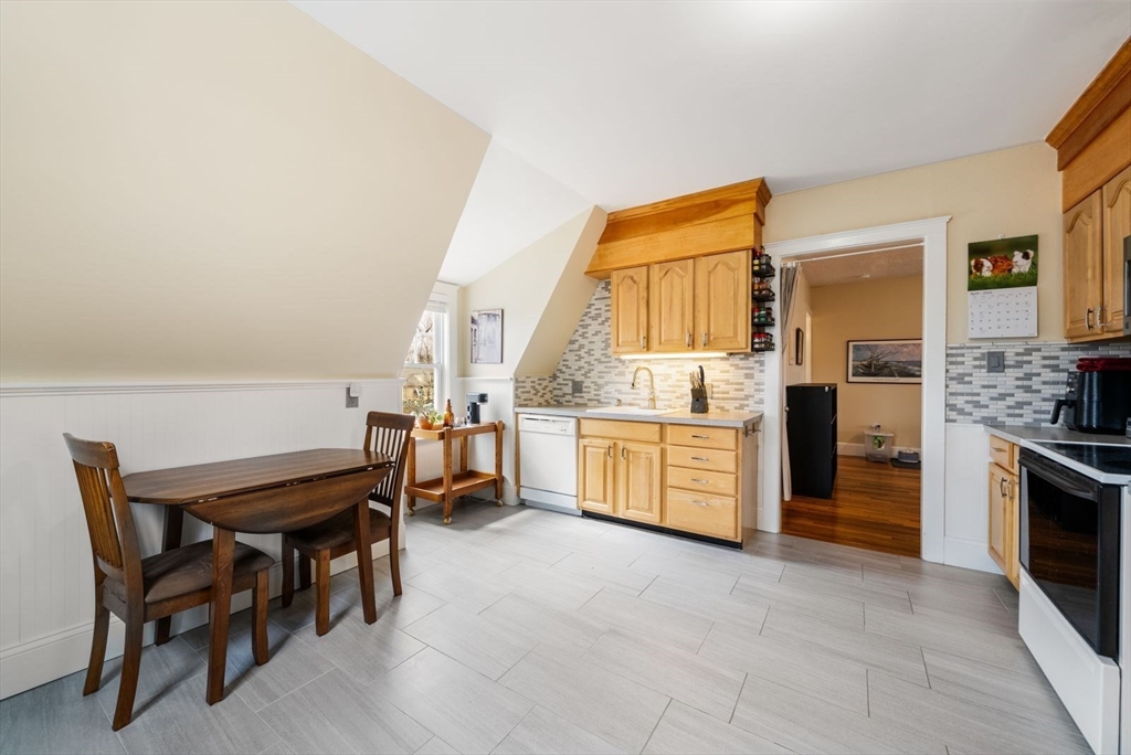4 Alden Street, Unit 3 Danvers, MA 01923 - Photo 9 of 33 a kitchen with a table chairs sink and refrigerator