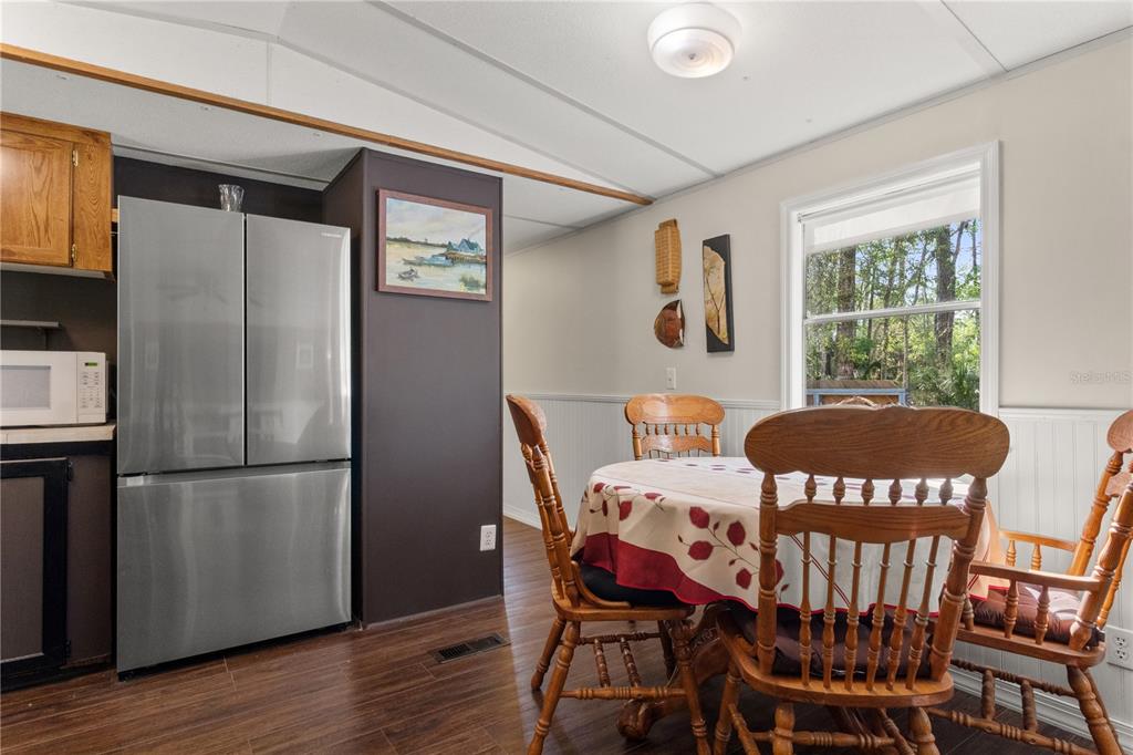 3650 176 Place Inglis, FL 34449 - Photo 20 of 49 a view of a dining room with furniture window and wooden floor