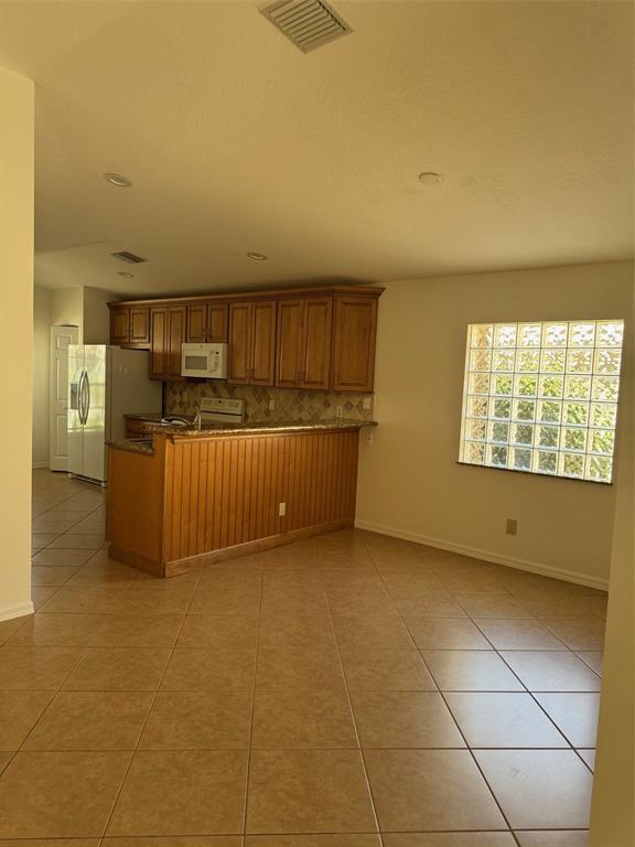 12082 Roma Road Boynton Beach, FL 33437 - Photo 5 of 14 a view of an empty room with a window